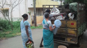 A bent Ramana digging into garbage and trying to segregate